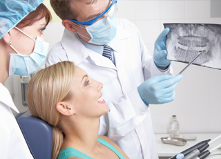 woman looking at xrays with dentist