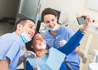 patient taking selfie with dental team