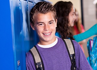 Teen boy at school with braces